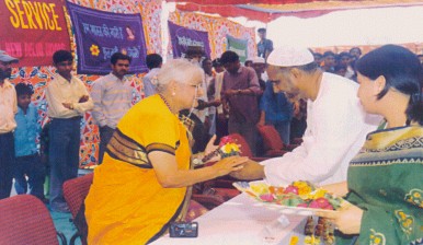 Dr.V.Mohini Giri presenting  flowers to the distinguished guests